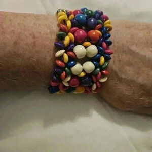 White, multicolored wooden slip on bracelet. Wide ban